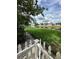 Serene backyard with a scenic pond view and white picket fence, ideal for relaxation at 13709 Juniper Blossom Dr, Tampa, FL 33618