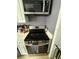Updated kitchen with stainless steel appliances including a microwave and electric range at 13709 Juniper Blossom Dr, Tampa, FL 33618