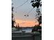 Picturesque sunset over the lake visible from a deck, offering a stunning view and peaceful ambiance at 13709 Juniper Blossom Dr, Tampa, FL 33618