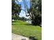 Scenic waterfront property featuring a boat dock and lush green lawn perfect for outdoor enjoyment at 13709 Juniper Blossom Dr, Tampa, FL 33618