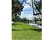 Scenic waterfront property featuring a boat dock and lush green lawn perfect for outdoor enjoyment at 13709 Juniper Blossom Dr, Tampa, FL 33618