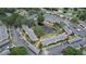 Aerial view featuring community buildings, parking, and a pond surrounded by trees at 13755 Orange Sunset Dr # 101, Tampa, FL 33618