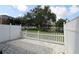 Back yard with fenced gate, pond, fountain and manicured lawn at 13755 Orange Sunset Dr # 101, Tampa, FL 33618