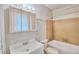 Clean bathroom featuring a tub with tiled wall, large sink and mirror, and standard toilet at 13755 Orange Sunset Dr # 101, Tampa, FL 33618