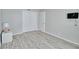 Cozy bedroom with wood-look flooring, a double closet, and neutral paint, creating a relaxing atmosphere at 13755 Orange Sunset Dr # 101, Tampa, FL 33618