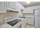 Efficient kitchen featuring white cabinets, stainless steel appliances, and marble-look countertops at 13755 Orange Sunset Dr # 101, Tampa, FL 33618