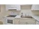 Efficient kitchen featuring white cabinets, stainless steel appliances, and marble-look countertops at 13755 Orange Sunset Dr # 101, Tampa, FL 33618