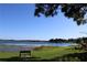 Scenic lake view with a bench overlooking the serene waters and lush greenery, creating a tranquil atmosphere at 13755 Orange Sunset Dr # 101, Tampa, FL 33618