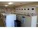 Clean community laundry room equipped with rows of modern washing machines and folding counters at 13755 Orange Sunset Dr # 101, Tampa, FL 33618