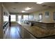 Bright community laundry room featuring multiple washers, dryers and folding tables at 13755 Orange Sunset Dr # 101, Tampa, FL 33618
