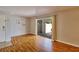 Bright living room featuring wood floors, sliding glass doors to outdoor patio, and neutral wall paint at 13755 Orange Sunset Dr # 101, Tampa, FL 33618