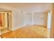 Spacious living room with wood-look floors, neutral walls, and sliding glass door with natural light at 13755 Orange Sunset Dr # 101, Tampa, FL 33618