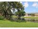 Scenic view of a tranquil pond and fountain surrounded by lush greenery in a quiet community at 13755 Orange Sunset Dr # 101, Tampa, FL 33618