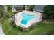 Aerial view of a community pool surrounded by lounge chairs and lush landscaping at 13755 Orange Sunset Dr # 101, Tampa, FL 33618
