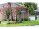 Charming street view featuring brick architecture, pink crepe myrtle trees, and a serene park bench at 13755 Orange Sunset Dr # 101, Tampa, FL 33618