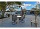 Enjoy the outdoors on this cozy patio with outdoor dining set, grill, and shell landscaping at 13800 Judy Ave, Hudson, FL 34667
