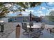 Beautiful backyard patio with dining set, grill, Tiki torches, and sliding glass door access to the home at 13800 Judy Ave, Hudson, FL 34667