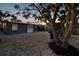 Backyard view showcasing the patio area, exterior of the home, and ample gravel landscaping at 13800 Judy Ave, Hudson, FL 34667