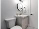 Bathroom with a modern vanity, round mirror, sleek black fixtures, and clean design at 13800 Judy Ave, Hudson, FL 34667