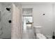 Modern bathroom featuring a black shower head, marble tiles, and a toilet at 13800 Judy Ave, Hudson, FL 34667