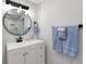 The bathroom boasts a sleek vanity, a round mirror, and modern fixtures at 13800 Judy Ave, Hudson, FL 34667