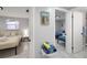 Bedroom with bright light, art, and access to another bedroom and bath at 13800 Judy Ave, Hudson, FL 34667