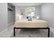 A serene bedroom with simple décor and a window that allows lots of natural light at 13800 Judy Ave, Hudson, FL 34667