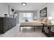 Bright bedroom featuring tiled flooring, ample natural light, and stylish dresser and nightstand at 13800 Judy Ave, Hudson, FL 34667