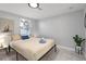 Inviting bedroom with light neutral tones and natural light from the window at 13800 Judy Ave, Hudson, FL 34667