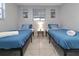 Charming bedroom featuring twin beds with bright bedding and stylish decor at 13800 Judy Ave, Hudson, FL 34667