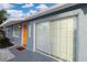 Charming single-story home featuring an inviting orange front door and sliding glass doors at 13800 Judy Ave, Hudson, FL 34667