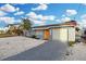Charming single-story home with a vibrant orange front door and a well-maintained, light gray exterior at 13800 Judy Ave, Hudson, FL 34667