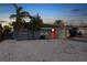 Charming single-story home with a vibrant orange front door and a well-maintained, light gray exterior at 13800 Judy Ave, Hudson, FL 34667