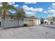 Charming single-story home with a vibrant orange front door and a well-maintained, light gray exterior at 13800 Judy Ave, Hudson, FL 34667