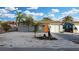 Well-kept home featuring an orange front door, shell landscaping, and mature tropical vegetation at 13800 Judy Ave, Hudson, FL 34667