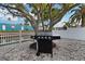Modern stainless steel grill for outdoor cooking on the property's shell landscaped yard at 13800 Judy Ave, Hudson, FL 34667