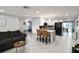 Open-concept kitchen features modern black appliances, white cabinets, and an island with bar seating at 13800 Judy Ave, Hudson, FL 34667