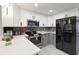 Modern kitchen featuring stainless steel appliances, white cabinetry, and sleek design at 13800 Judy Ave, Hudson, FL 34667