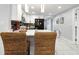 Open kitchen features black appliances, white cabinets, an island with seating, and modern decor at 13800 Judy Ave, Hudson, FL 34667