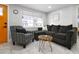Cozy living area featuring an orange front door, comfortable seating, and a decorative wood table at 13800 Judy Ave, Hudson, FL 34667