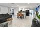 Open-concept living space boasts modern tile flooring and a stylish kitchen with a black refrigerator at 13800 Judy Ave, Hudson, FL 34667
