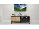 Stylish entertainment center with TV, woven cabinet, and minimalist decor accents at 13800 Judy Ave, Hudson, FL 34667