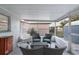 Covered outdoor patio features seating and a hanging chair at 13800 Judy Ave, Hudson, FL 34667