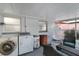 Covered patio with laundry machines, seating, and a hanging chair at 13800 Judy Ave, Hudson, FL 34667