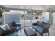 Enclosed porch with comfortable seating, great for enjoying the outdoors in any weather at 13800 Judy Ave, Hudson, FL 34667