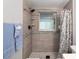 Walk-in shower features stylish tile, a window, and modern fixtures at 13800 Judy Ave, Hudson, FL 34667