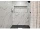 A modern shower boasts tile walls, stylish fixtures, and a convenient built-in shelf at 13800 Judy Ave, Hudson, FL 34667