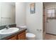 Compact bathroom with wood vanity, tile floor, and walk-in shower with direct backyard access at 14266 Creek Run Dr, Riverview, FL 33579