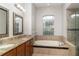 Primary bathroom featuring double sinks, granite countertops, soaking tub and glass shower at 14266 Creek Run Dr, Riverview, FL 33579