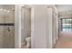 Bathroom featuring glass shower, toilet, and access to the bedroom and hallway at 14266 Creek Run Dr, Riverview, FL 33579